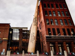 Exterior of the Louisville Slugger Museum & Factory with its iconic giant baseball bat in downtown Louisville—an event landmark often featured in Michaelis Events’ corporate event management experiences.