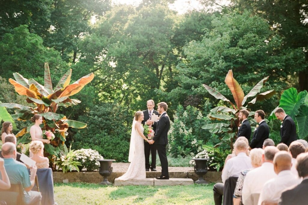 Wedding ceremony under string lights at Yew Dell Gardens, a botanical venue in Louisville KY