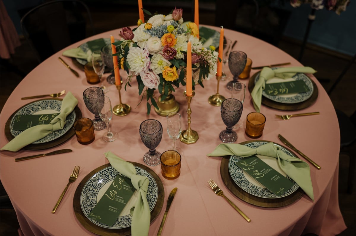 Elegant Derby-themed corporate event table setting by Michaelis Events at the Frazier History Museum, featuring floral centerpiece and colorful glassware.