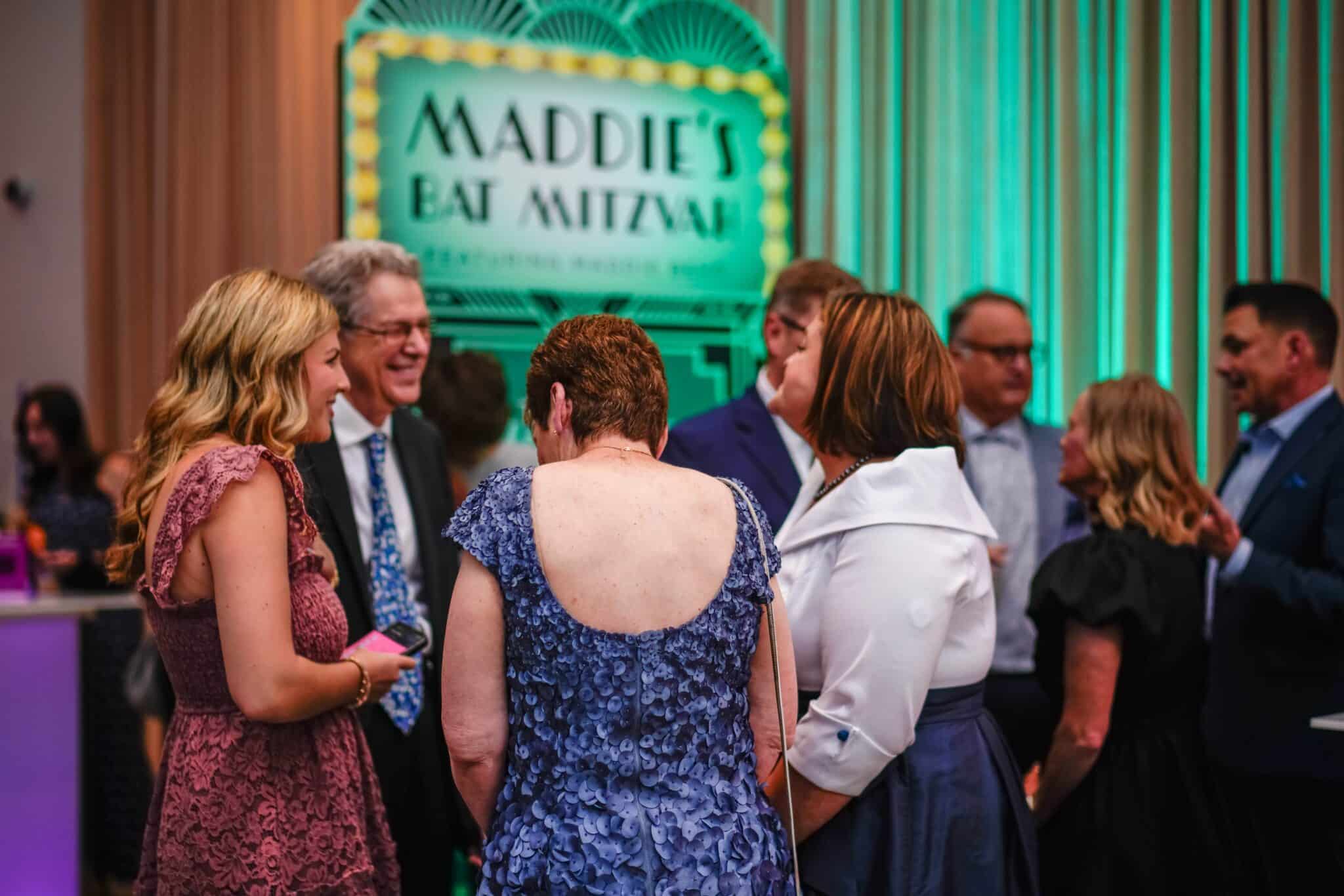 Guests mingle during Maddie’s Bat Mitzvah celebration in Louisville, with vibrant event design by Michaelis Events. Captured by TIMB Photography.
