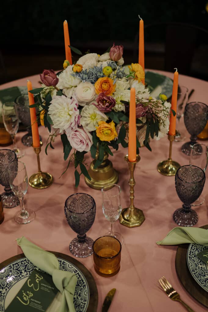 Derby-themed corporate event table setting with floral centerpiece and custom menus by Michaelis Events at the Frazier History Museum.